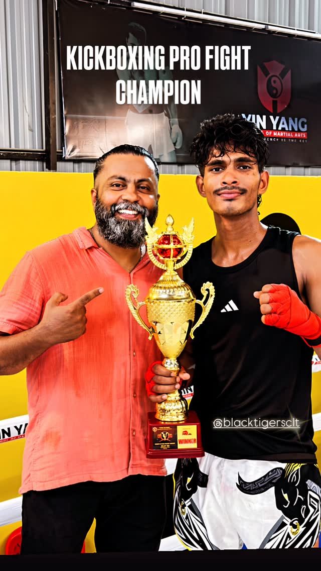 Coach Praveen Raj with a Black Tigers kickboxing champion and trophy
